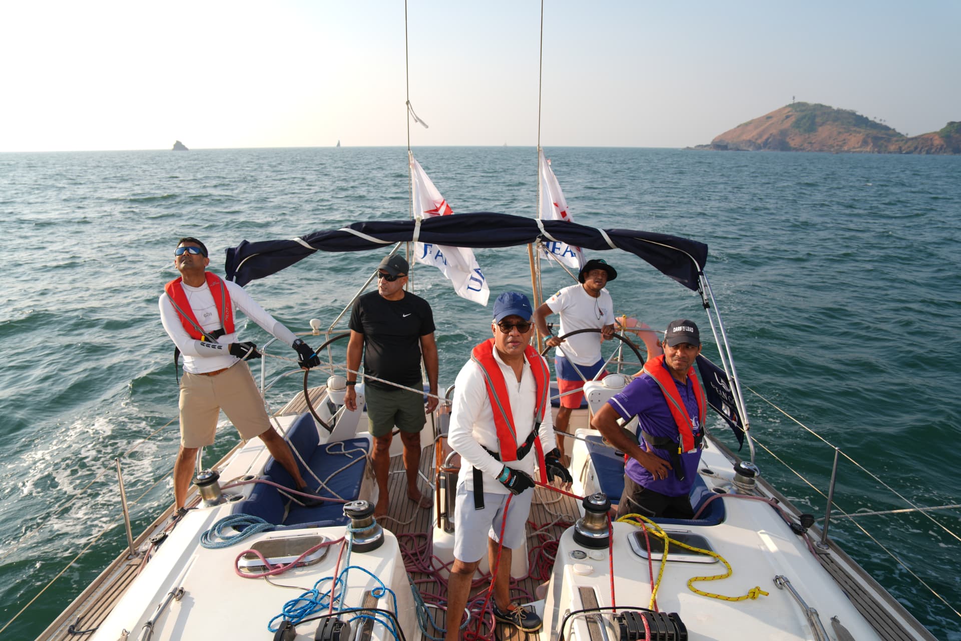 Ocean Gold crew sailing with the headland visible from the cockpit during Season I